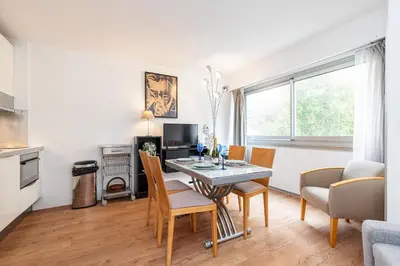 a kitchen and dining room with a table and chairs at Central 1 Bdr in Nice