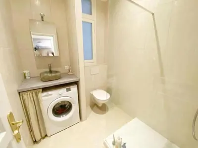 a bathroom with a washing machine and a toilet at Luxurious 2 bedrooms on Promenades des Anglais in Nice
