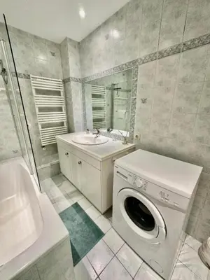 a bathroom with a washing machine and a sink at Luxurious 2 bedrooms on Promenades des Anglais in Nice