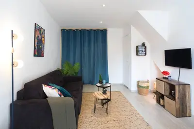 a living room with a couch and a tv at L5 2mins Walk to the Beach Heart of Old Town Nice in Nice