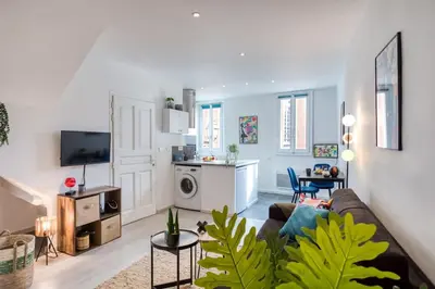 a living room with a couch and a kitchen at L5 2mins Walk to the Beach Heart of Old Town Nice in Nice