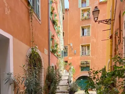 an alley between two buildings with stairs leading up to them at L5 2mins Walk to the Beach Heart of Old Town Nice in Nice
