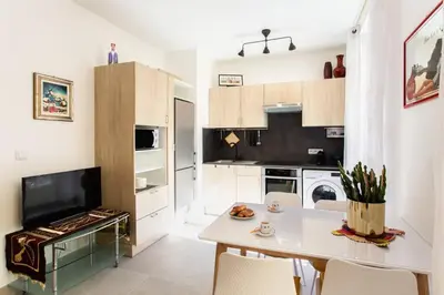 a kitchen with a white table and chairs in a room at L6 2Rooms 2mins walk from Negresco & Sea AC-Wifi in Nice