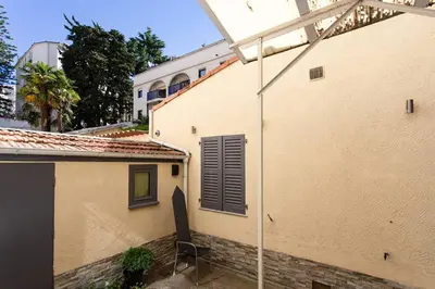 a chair sitting on a patio next to a building at L6 2Rooms 2mins walk from Negresco & Sea AC-Wifi in Nice