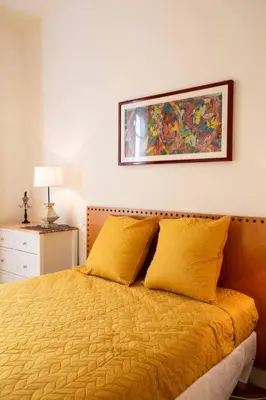 a bedroom with a yellow bed with a picture on the wall at L6 2Rooms 2mins walk from Negresco & Sea AC-Wifi in Nice