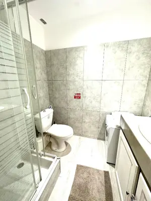 a bathroom with a toilet and a glass shower at Studio mezzanine sur le port in Nice