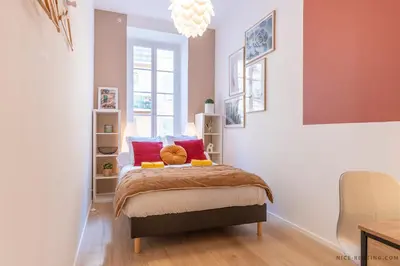 a bedroom with a bed with red pillows on it at Nice Renting - BAVASTRO - Luxurious Loft - 2 BedRoom - AC - Balcony - Trendy Neighborhood in Nice