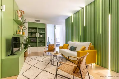 a living room with green walls and a yellow couch at Nice Renting - BAVASTRO - Luxurious Loft - 2 BedRoom - AC - Balcony - Trendy Neighborhood in Nice