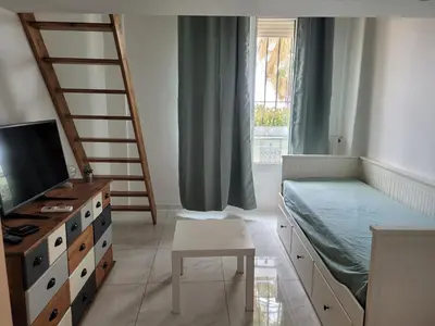 a bedroom with a bed and a desk and a tv at 2 pièces promenade des anglais in Nice