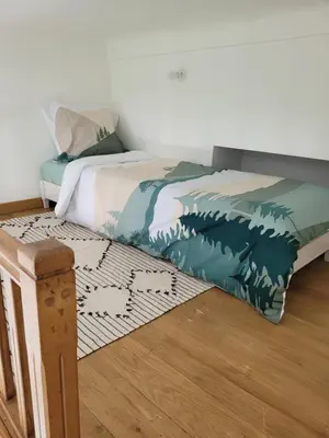 a bedroom with a bed with a painting of the wave at 2 pièces promenade des anglais in Nice