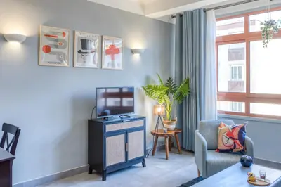 a living room with a table and a chair at L12 Port window 1Bedroom Wifi 5mins beach & Nice's Cap in Nice