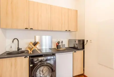 a kitchen with a washing machine and a sink at L13 Central flat 5mins walk to beach AC/Balcon/WIFI in Nice