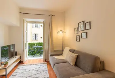 a living room with a couch and a television at L13 Central flat 5mins walk to beach AC/Balcon/WIFI in Nice