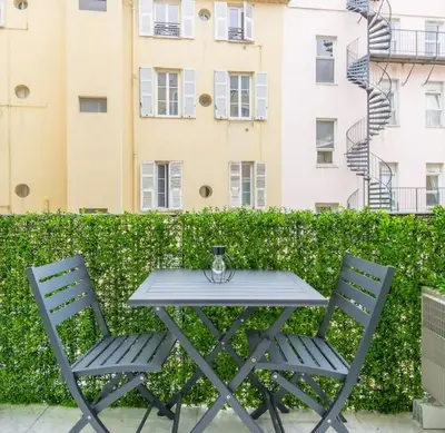a picnic table and two chairs in front of a building at L13 Central flat 5mins walk to beach AC/Balcon/WIFI in Nice