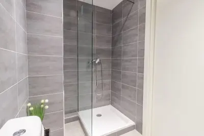 a bathroom with a shower with a toilet and a sink at L13 Central flat 5mins walk to beach AC/Balcon/WIFI in Nice