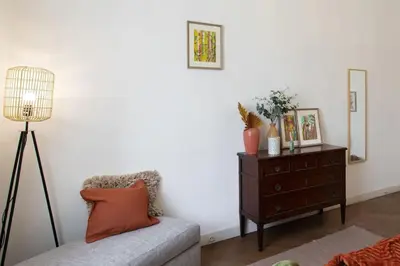 a living room with a couch and a dresser with a lamp at L14 2P Promenade Vue Mer climatisé, spacieux/ Balcon in Nice