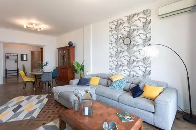 a living room with a couch and a table at L14 2P Promenade Vue Mer climatisé, spacieux/ Balcon in Nice