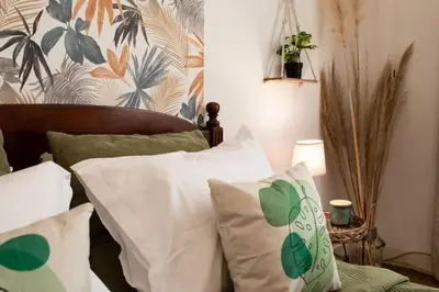 a bedroom with a bed with white and green pillows at L14 2P Promenade Vue Mer climatisé, spacieux/ Balcon in Nice
