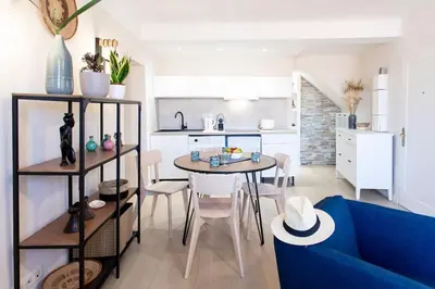 a living room with a table and a blue couch at L16 Suite Malonat Vieux Nice 1 min Mer/ 2 chbres & AC in Nice
