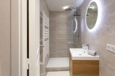 a bathroom with a sink and a shower with a mirror at L16 Suite Malonat Vieux Nice 1 min Mer/ 2 chbres & AC in Nice