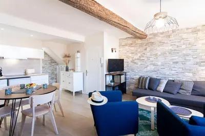 a living room with a blue couch and a table at L16 Suite Malonat Vieux Nice 1 min Mer/ 2 chbres & AC in Nice