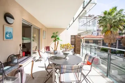 a patio with a table and chairs on a balcony at L18 Central Parking terrace AC 10mins walk to beaches in Nice