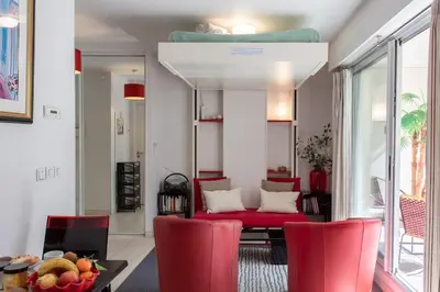 a living room with red chairs and a red couch at L18 Central Parking terrace AC 10mins walk to beaches in Nice