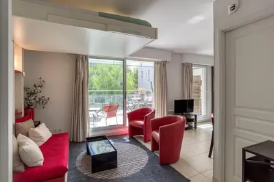a living room with a red couch and chairs at L18 Central Parking terrace AC 10mins walk to beaches in Nice