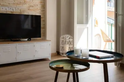 a living room with a tv and a coffee table at L19 1BDR Massena central 2mins Sea/PromenadeAC/Balcony in Nice