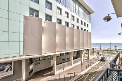 an external view of a building with the ocean in the background at L29 Lenval beach at 1min walk to Sea front AC Balcony in Nice