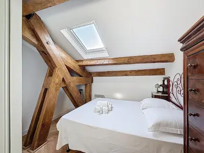 a bedroom with a white bed with a skylight at Appartement Atypique cœur de ville -AC- in Nice