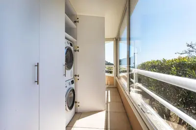 a laundry room with two washing machines on a balcony at EZE VISTA AP4328 By Riviera Holiday Homes in Èze