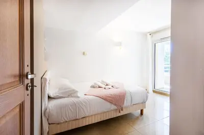 a bedroom with a bed with white sheets and a window at EZE VISTA AP4328 By Riviera Holiday Homes in Èze