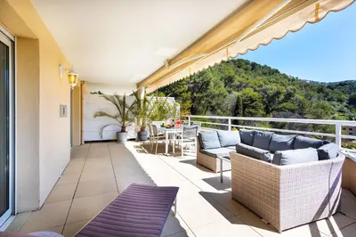a patio with chairs and a table on a balcony at EZE VISTA AP4328 By Riviera Holiday Homes in Èze