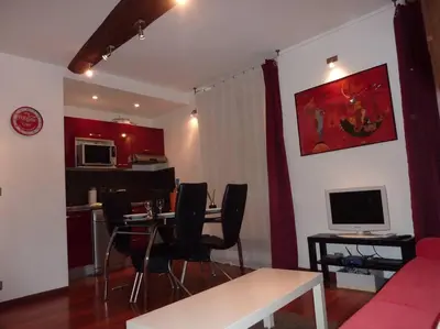a living room with a couch and a table with chairs at Vieux Nice 2 pièces Appartement SAN REMO in Nice