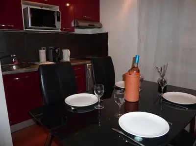 a dining room table with chairs and wine glasses at Vieux Nice 2 pièces Appartement SAN REMO in Nice