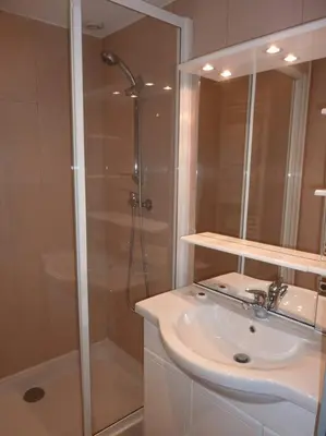 a white bathroom with a shower and a sink at Vieux Nice 2 pièces Appartement SAN REMO in Nice