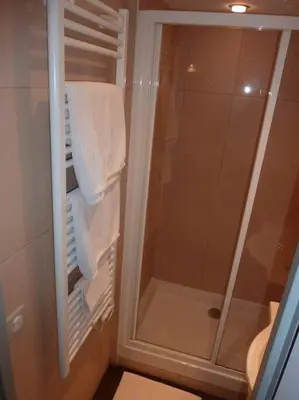 a bathroom with a shower with white towels at Vieux Nice 2 pièces Appartement SAN REMO in Nice