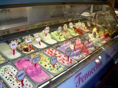 a display case filled with cakes and other desserts at Vieux Nice 2 pièces Appartement SAN REMO in Nice
