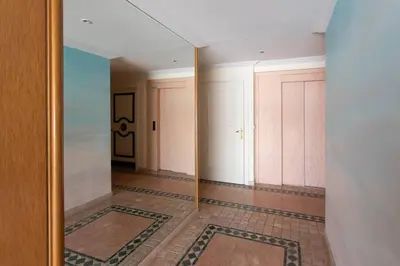 a hallway with two doors and a tile floor at L34 Hermès Suite terrace parking AC 2mins SEA in Saint-Jean-Cap-Ferrat