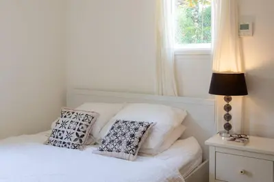a bedroom with a bed with pillows and a window at L34 Hermès Suite terrace parking AC 2mins SEA in Saint-Jean-Cap-Ferrat