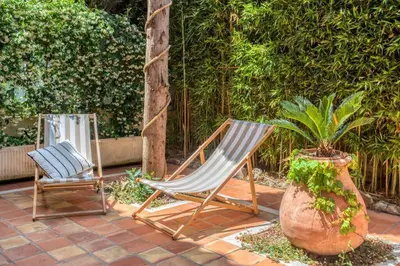 two chairs sitting on a patio next to a plant at L34 Hermès Suite terrace parking AC 2mins SEA in Saint-Jean-Cap-Ferrat