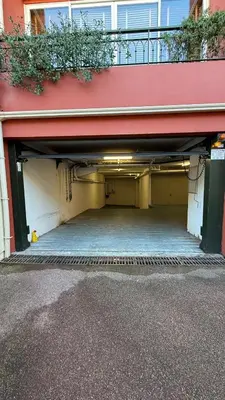 an empty parking garage with a red building at L34 Hermès Suite terrace parking AC 2mins SEA in Saint-Jean-Cap-Ferrat