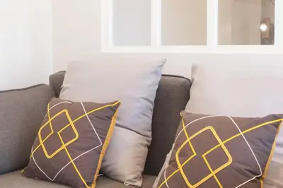 two pillows on a couch in a living room at L36 Sea view terrace 10min walking to sea/Parking & AC in Nice