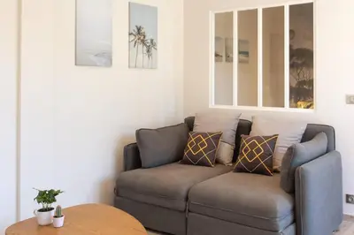 a living room with a couch and a table at L36 Sea view terrace 10min walking to sea/Parking & AC in Nice