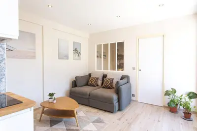 a living room with a couch and a table at L36 Sea view terrace 10min walking to sea/Parking & AC in Nice