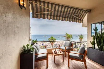 a living room with a view of the ocean at L39 Suite Promenade des Anglais, Vue Mer Terrasse&WIFI in Nice