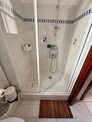 a shower with a glass door in a bathroom at Grimaldi Central AC 2 terraces Wifi 5mins SEA in Nice