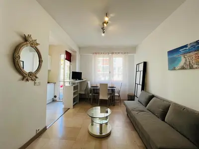 a living room with a couch and a table at Grand studio de 30 m2 Promenade des Anglais in Nice