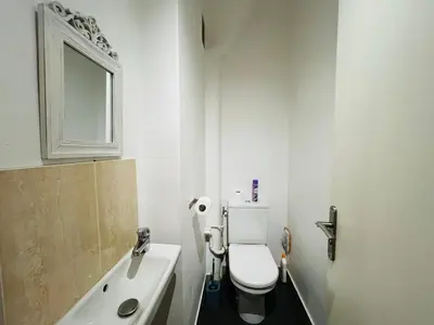 a bathroom with a toilet and a sink and a mirror at Grand studio de 30 m2 Promenade des Anglais in Nice
